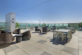The rooftop terrace of the building has tables and chairs